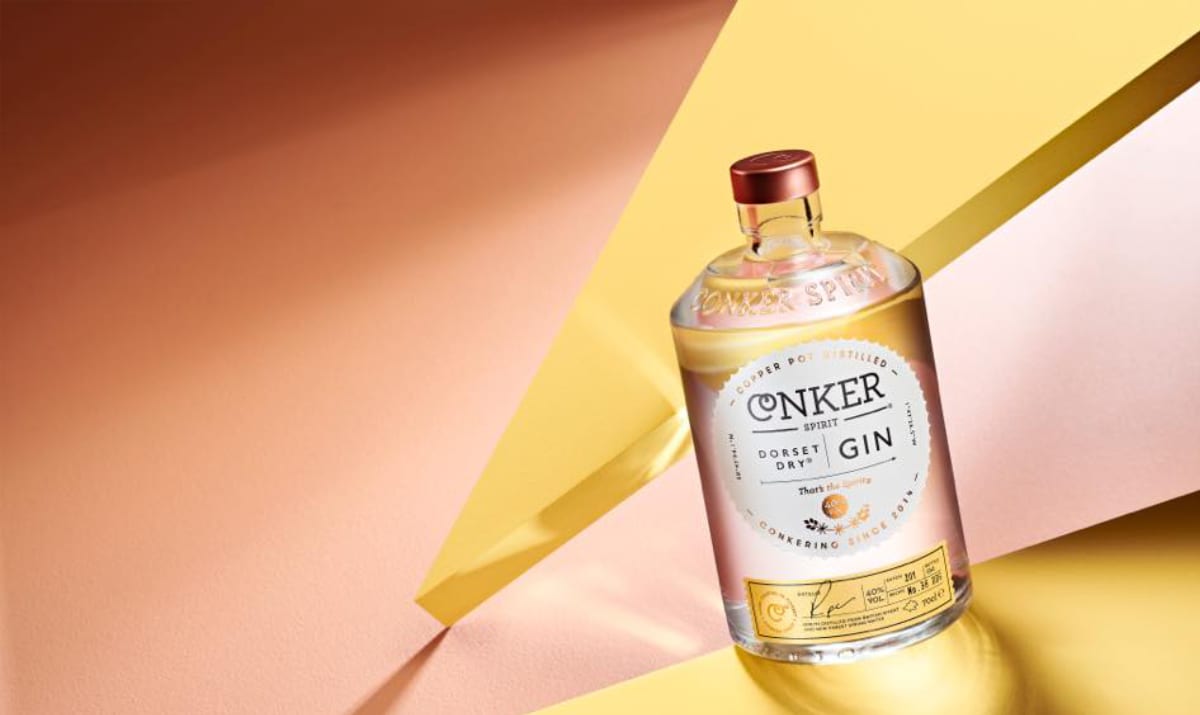 a bottle of conker spirit gin against a yellow background
