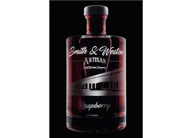 smith and western bottle against a black background