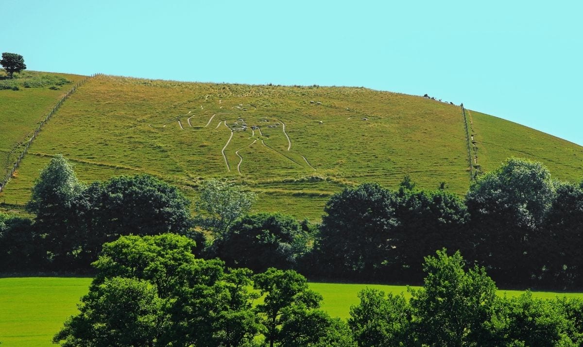 cerne abbas giant in the distance with surrounding fields