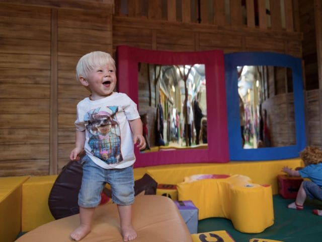 small child enjoying a play area at farmer palmers