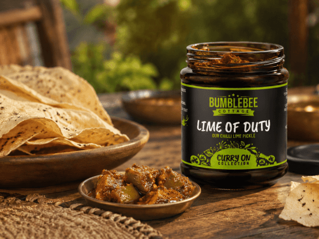 Jar of Bumblebee “Lime of Duty” chilli lime pickle served with poppadoms and a small dish of pickle.