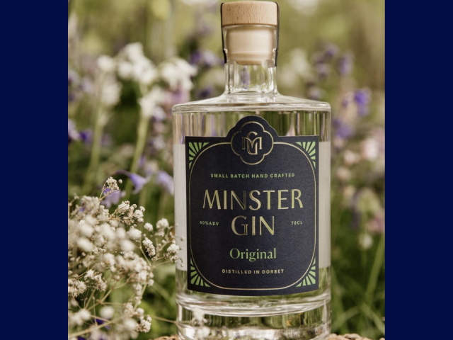 Minster Gin Original by Beaucroft Beverages, a handcrafted small-batch Dorset gin, displayed amongst wildflowers and countryside blooms in Wimborne Minster.