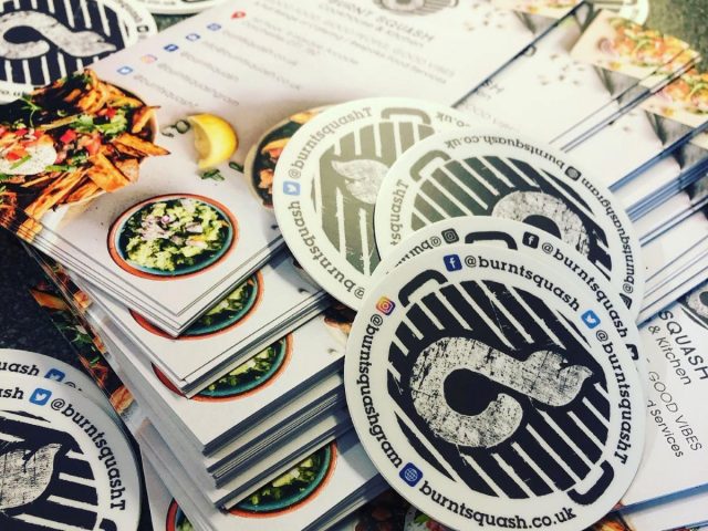 Branded Burnt Squash Kitchen & Bakery marketing materials, including business cards, stickers and promotional literature showcasing Dorset artisan bakery and catering services.