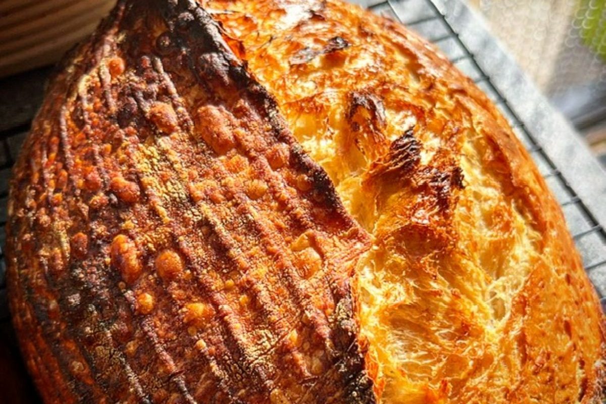 Artisan sourdough loaf with a crisp golden crust and open crumb, freshly baked by The Burnt Squash Kitchen & Bakery, a Dorset artisan bakery.